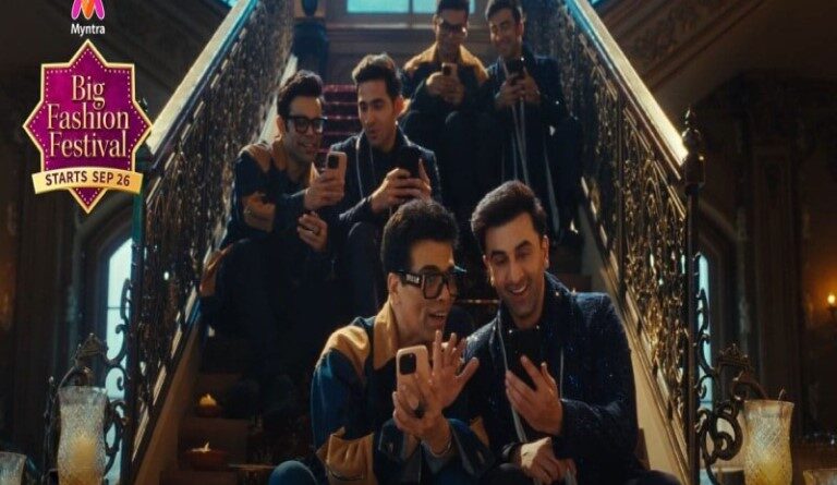 a group of men taking a picture on their cell phones